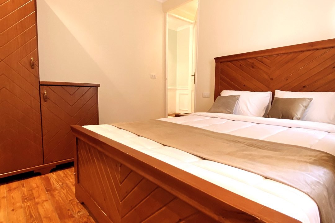 Double room with a wooden bed at Cairo House Hostel in Downtown Cairo